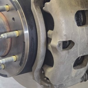 Heavy-duty brake rotor and caliper bracket with the wheel removed