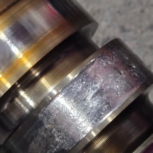 Diesel crankshaft showing heat discoloration and wear across multiple journals