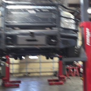 Truck raised on a two-post lift in the main shop bay