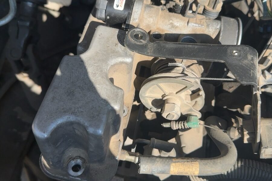 Top of the engine showing valve covers and ignition components during fuel and engine management service
