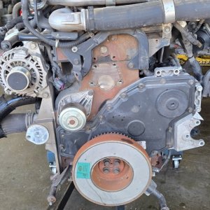 Diesel engine removed from the vehicle and set on the shop floor for rebuild work