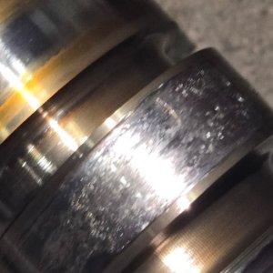 Close-up of a worn and scored diesel crankshaft journal