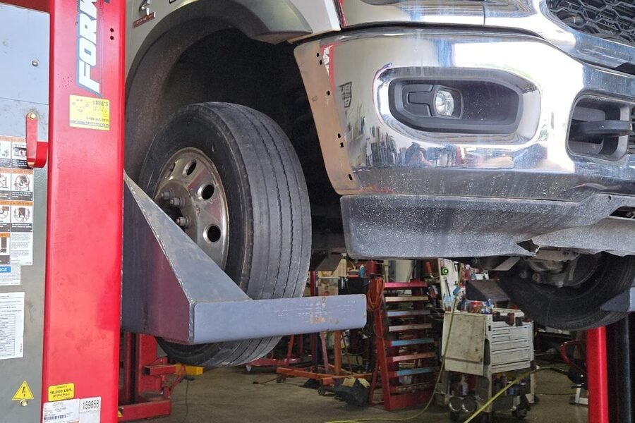Commercial fleet truck on the lift with the front end disassembled for repair