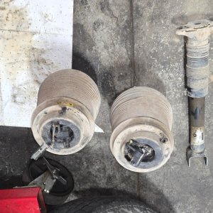 Worn strut and spring assemblies removed from a vehicle