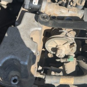 Top of the engine showing valve covers and ignition components during fuel and engine management service