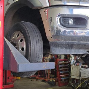 Commercial fleet truck on the lift with the front end disassembled for repair
