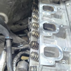 Engine with the valve cover removed showing the cylinder head and intake ports